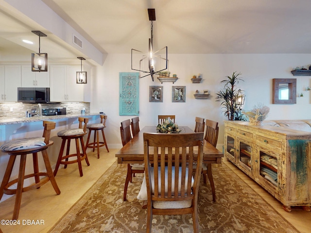 dining area featuring a notable chandelier