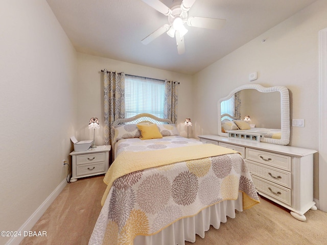 bedroom featuring light carpet and ceiling fan