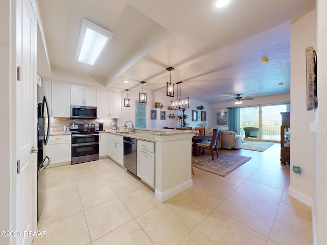 kitchen with kitchen peninsula, hanging light fixtures, sink, white cabinetry, and appliances with stainless steel finishes