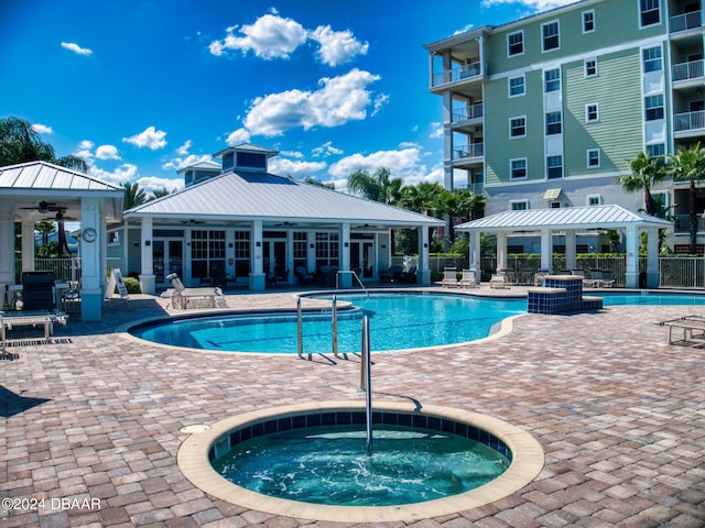 view of swimming pool with a community hot tub, a gazebo, and a patio area