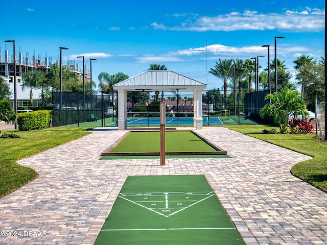 view of home's community featuring tennis court, a yard, and a gazebo