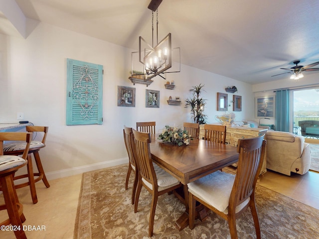 tiled dining space featuring ceiling fan with notable chandelier