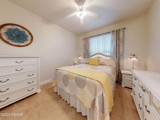 bedroom with light colored carpet and ceiling fan