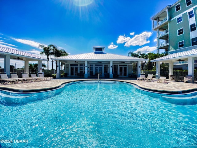 view of swimming pool featuring exterior bar and a patio area