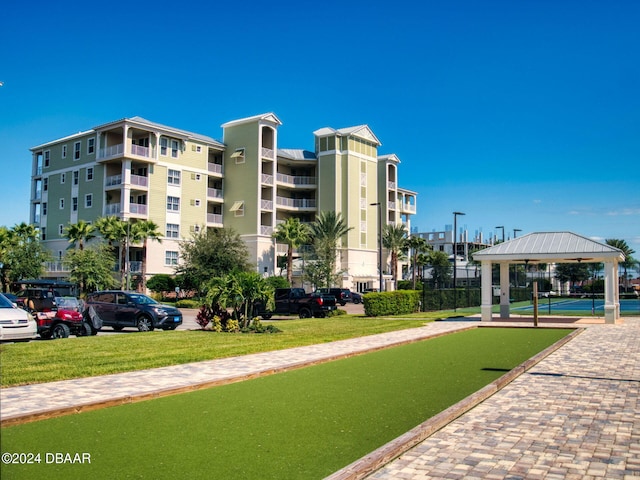 view of property's community with a lawn and a gazebo