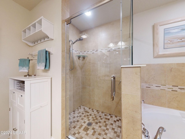 bathroom featuring shower with separate bathtub