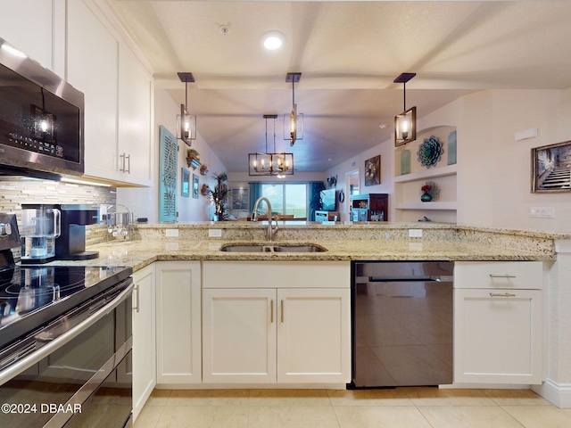 kitchen with white cabinetry, sink, appliances with stainless steel finishes, light stone countertops, and pendant lighting