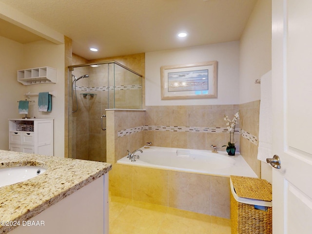 bathroom with shower with separate bathtub and vanity