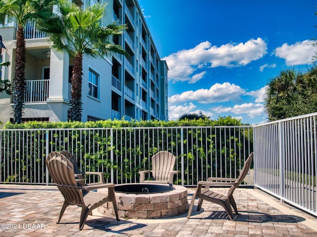 view of patio / terrace featuring a balcony and a fire pit