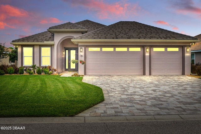 126 Briargate Look, Ormond Beach, FL 32174 - view of front of home featuring an attached garage, decorative driveway, a front yard, and stucco siding