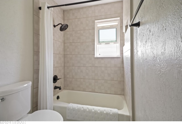 bathroom with toilet and shower / tub combo with curtain