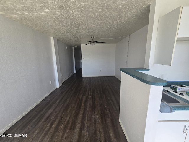 interior space featuring ceiling fan and dark hardwood / wood-style floors