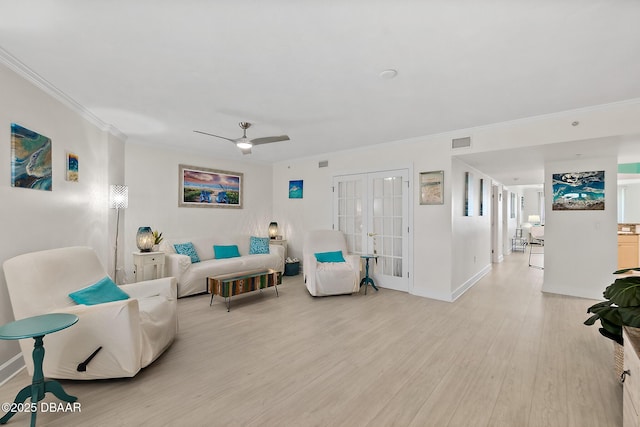 living room featuring french doors, baseboards, visible vents, crown molding, and light wood-style floors