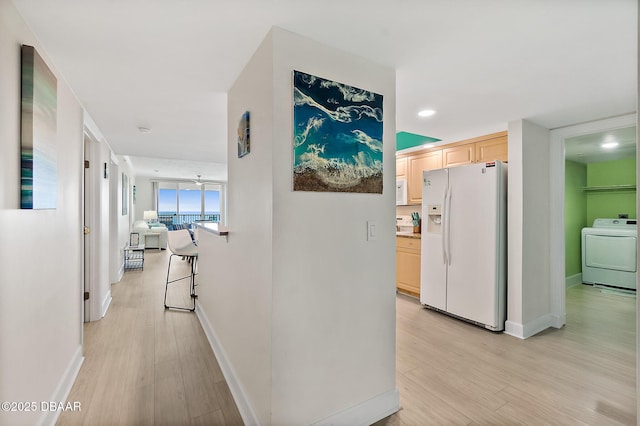 hall with baseboards, recessed lighting, washer / clothes dryer, and light wood-type flooring