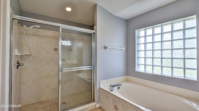 bathroom with shower with separate bathtub