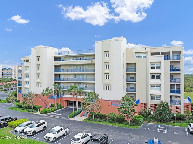 5300 S Atlantic Ave Unit 6-301, New Smyrna Beach, FL 32169 - view of apartment building / complex with uncovered parking