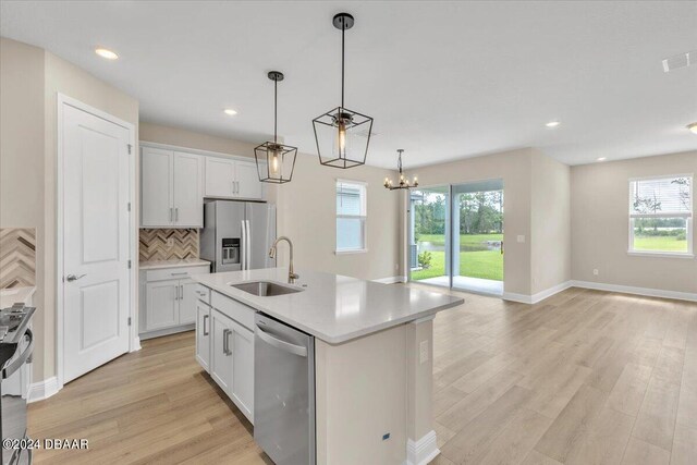 3116 Legends Preserve Dr, Daytona Beach, FL 32124 - kitchen featuring appliances with stainless steel finishes, a sink, healthy amount of natural light, light wood-style floors, and recessed lighting