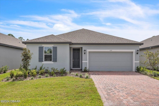 3116 Legends Preserve Dr, Daytona Beach, FL 32124 - single story home featuring decorative driveway, stucco siding, a garage, roof with shingles, and a front yard
