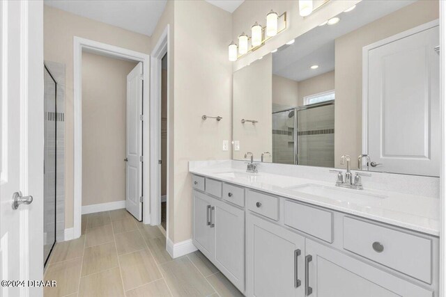 3116 Legends Preserve Dr, Daytona Beach, FL 32124 - bathroom featuring a shower stall, double vanity, baseboards, and recessed lighting
