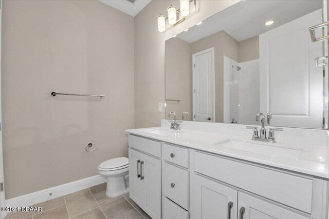 3116 Legends Preserve Dr, Daytona Beach, FL 32124 - full bath with double vanity, toilet, baseboards, a shower, and tile patterned flooring