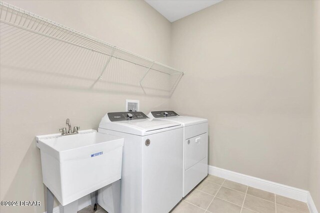 3116 Legends Preserve Dr, Daytona Beach, FL 32124 - laundry area with independent washer and dryer, baseboards, and light tile patterned flooring
