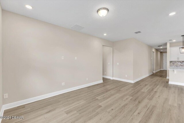3116 Legends Preserve Dr, Daytona Beach, FL 32124 - unfurnished living room featuring light wood finished floors, baseboards, and recessed lighting