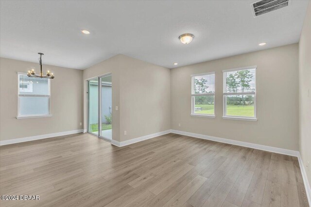 3116 Legends Preserve Dr, Daytona Beach, FL 32124 - spare room featuring a chandelier, healthy amount of natural light, baseboards, and recessed lighting