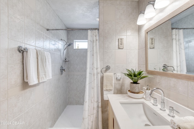 bathroom featuring a shower with curtain, tile walls, and vanity