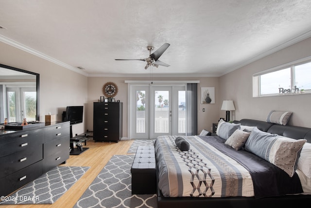 bedroom featuring a textured ceiling, light wood-type flooring, ceiling fan, and crown molding