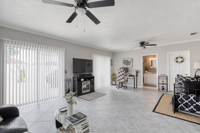 tiled living room featuring ornamental molding, ceiling fan, and a healthy amount of sunlight