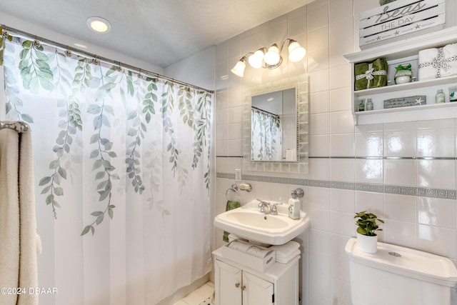 bathroom with vanity, backsplash, a shower with shower curtain, toilet, and tile walls