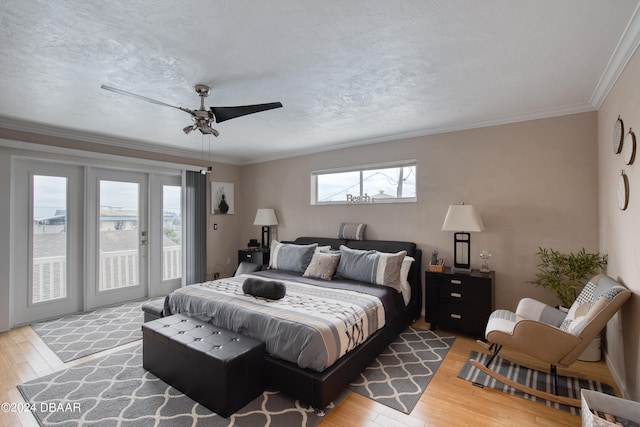 bedroom with light wood-type flooring, ornamental molding, access to outside, ceiling fan, and multiple windows