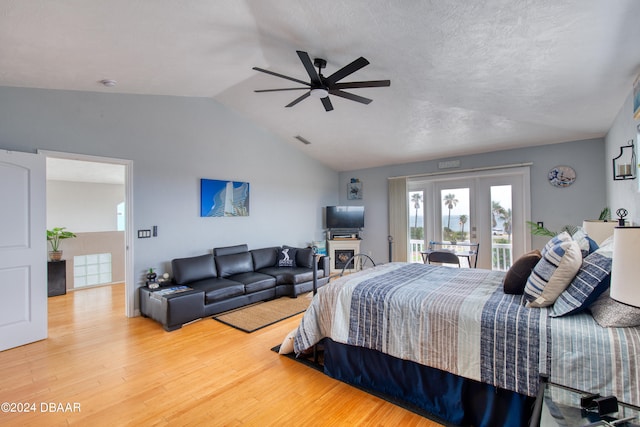 bedroom featuring access to exterior, hardwood / wood-style floors, ceiling fan, and lofted ceiling