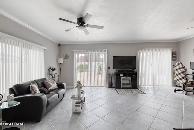 tiled living room featuring ceiling fan and crown molding