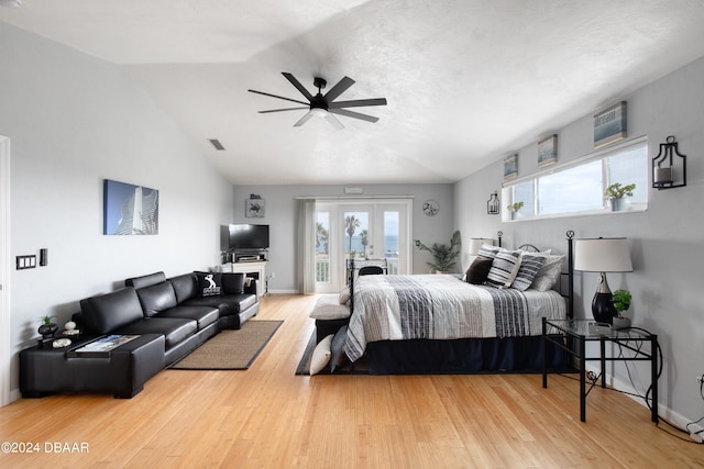 bedroom featuring multiple windows, ceiling fan, hardwood / wood-style floors, and vaulted ceiling