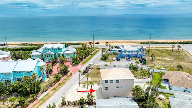 drone / aerial view featuring a view of the beach and a water view