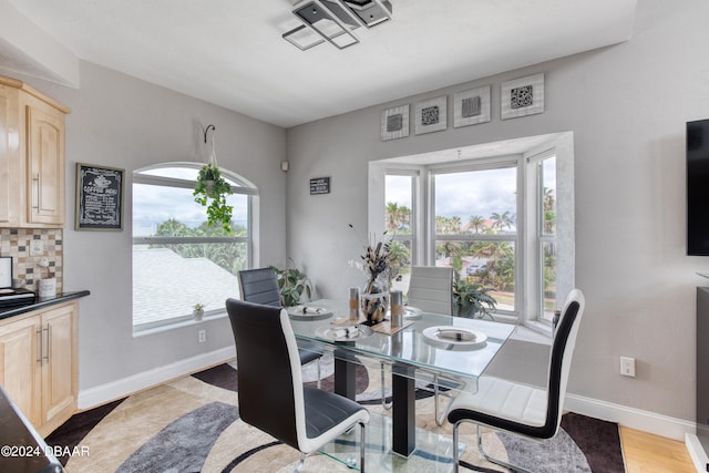 dining space with hardwood / wood-style floors and a healthy amount of sunlight