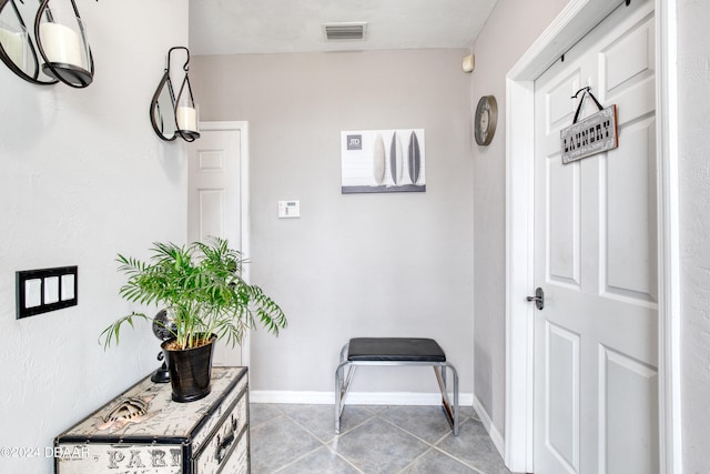 corridor featuring light tile patterned flooring