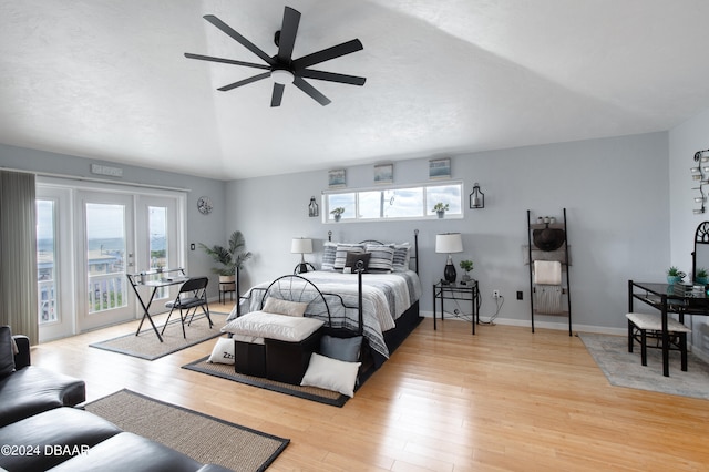 bedroom featuring light wood-type flooring, access to outside, ceiling fan, and lofted ceiling