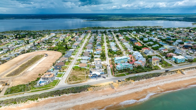 aerial view with a water view and a view of the beach