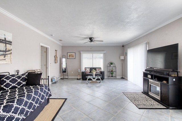 living room featuring ceiling fan, ornamental molding, a textured ceiling, and light tile patterned floors