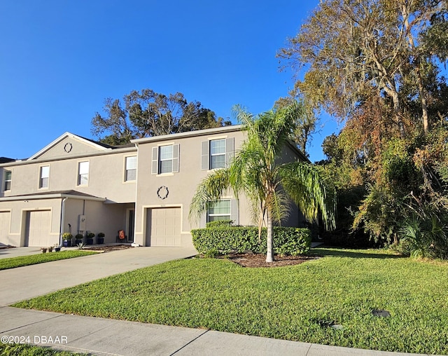 view of front of house featuring a front lawn and a garage