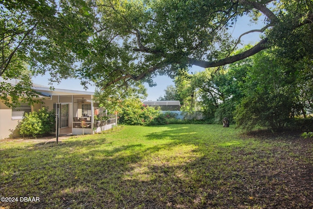 view of yard featuring a sunroom