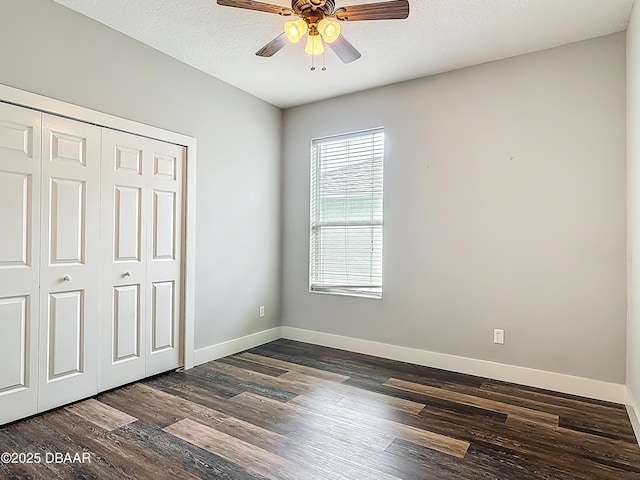 4225 Bristle Cone Way, Port Orange, FL 32129 - unfurnished bedroom with dark wood-style flooring, a closet, ceiling fan, and a textured ceiling