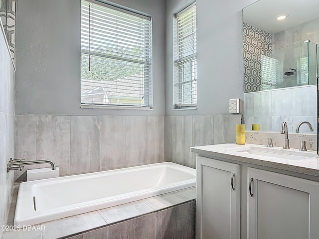 4225 Bristle Cone Way, Port Orange, FL 32129 - full bath featuring a garden tub, vanity, tiled shower, and tile walls