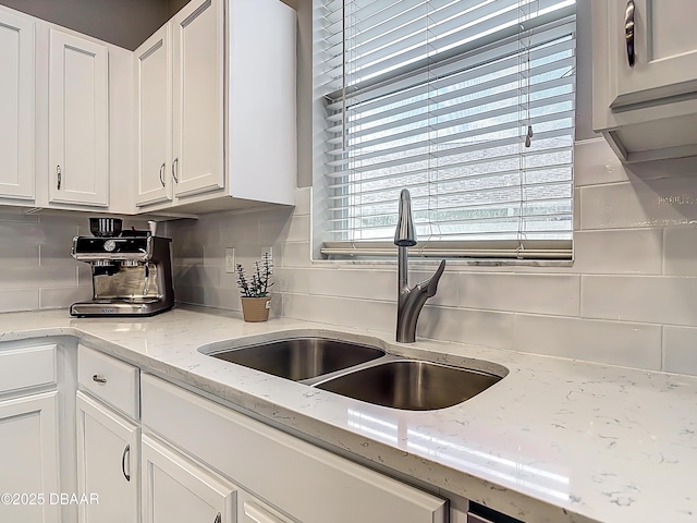 4225 Bristle Cone Way, Port Orange, FL 32129 - kitchen featuring tasteful backsplash, white cabinets, and light stone counters