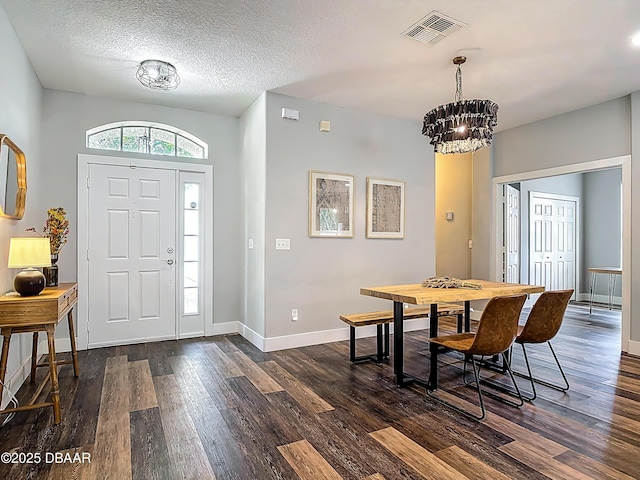 4225 Bristle Cone Way, Port Orange, FL 32129 - foyer with dark wood finished floors, a chandelier, and a textured ceiling