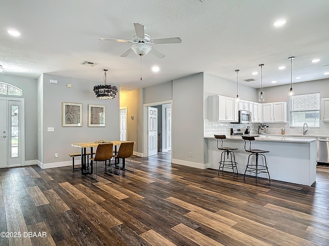 4225 Bristle Cone Way, Port Orange, FL 32129 - kitchen featuring dark wood-style flooring, recessed lighting, white cabinets, light countertops, and appliances with stainless steel finishes
