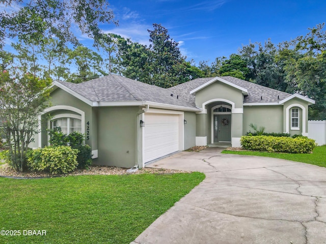 4225 Bristle Cone Way, Port Orange, FL 32129 - ranch-style home with stucco siding, concrete driveway, a front lawn, a shingled roof, and a garage