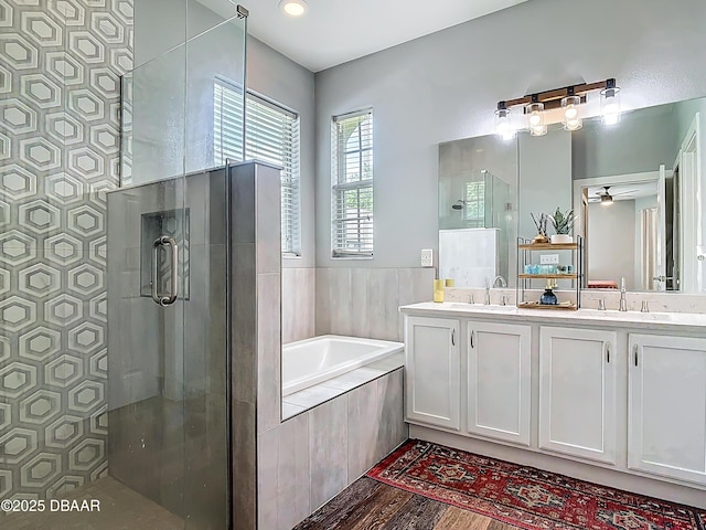 4225 Bristle Cone Way, Port Orange, FL 32129 - full bath with tiled shower, double vanity, a garden tub, and ceiling fan